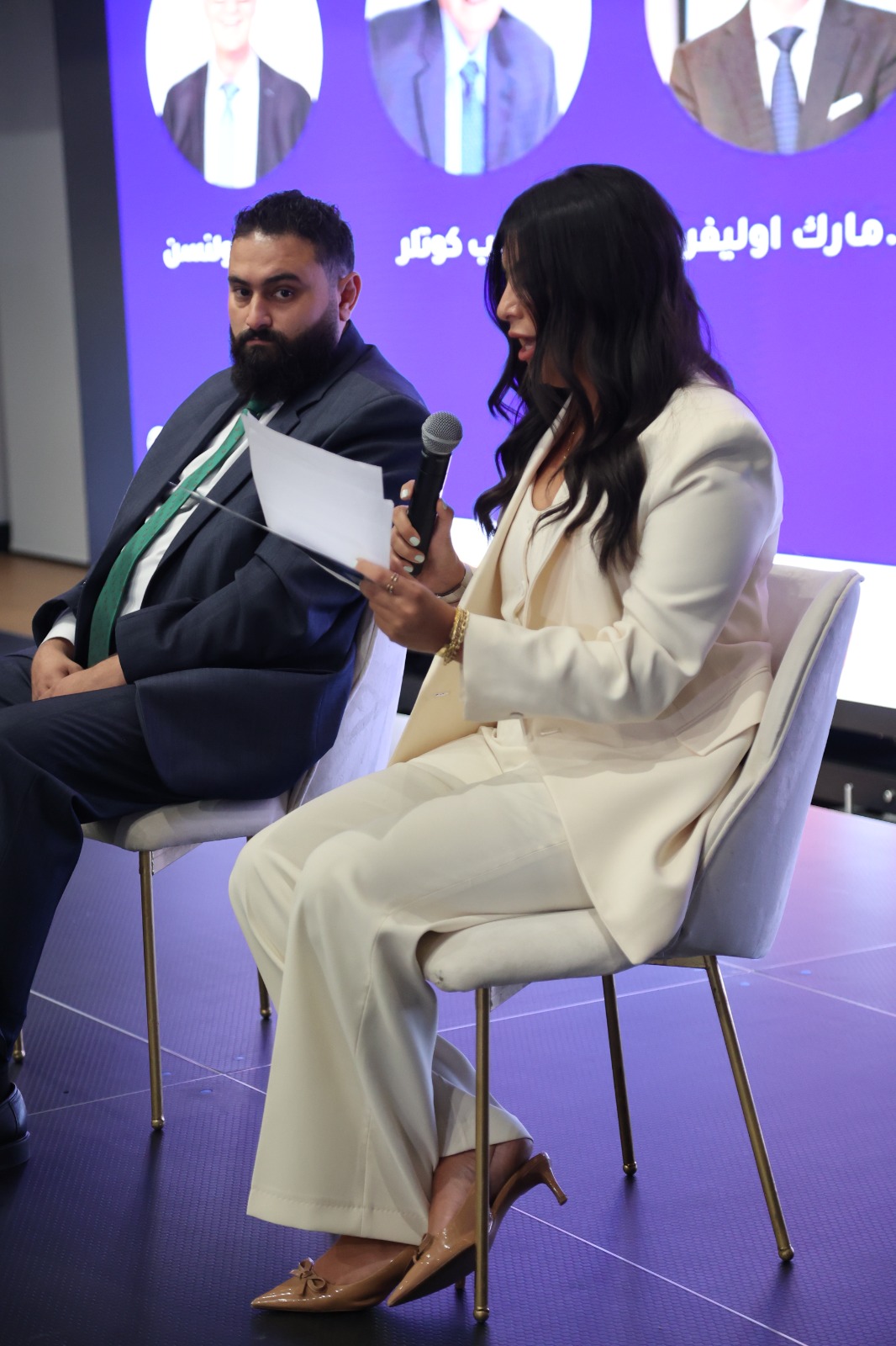 Abdullrahman Zidan on stage with the host holding a microphone