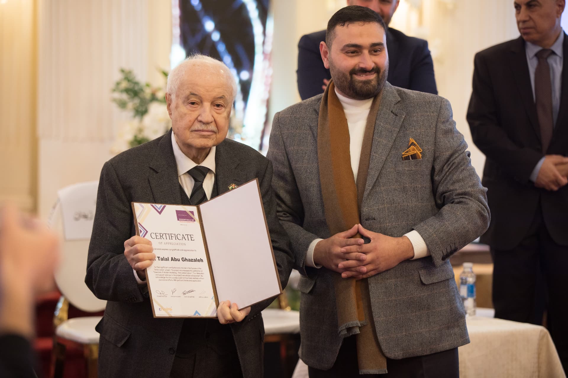 Abdullrahman Zidan with Dr. Talal Abu-Ghazaleh holding a certificate